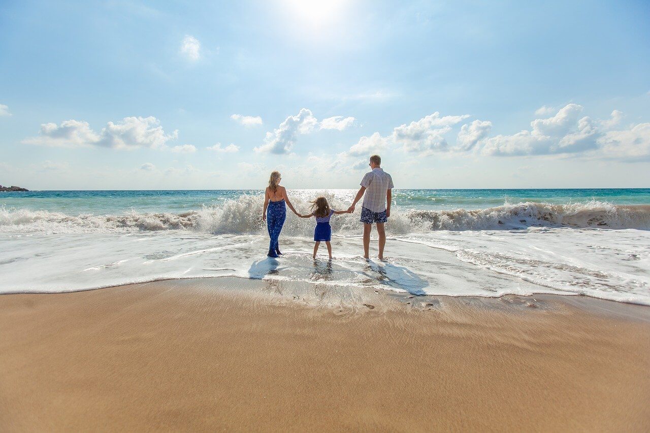 A family on the beach thinking about the best places in Maryland to raise a family