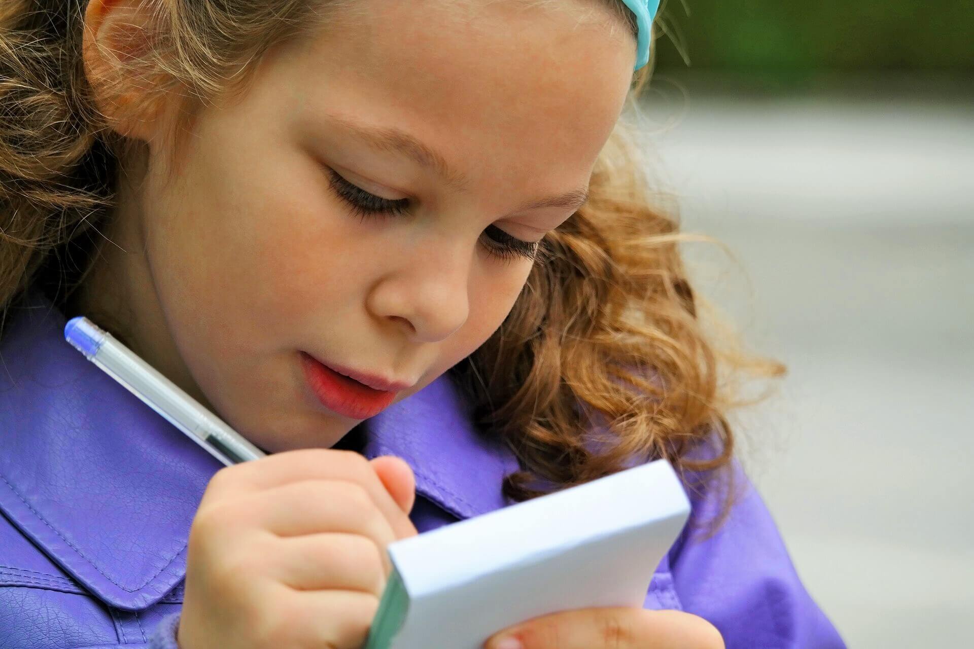 A girl writing in a notepad