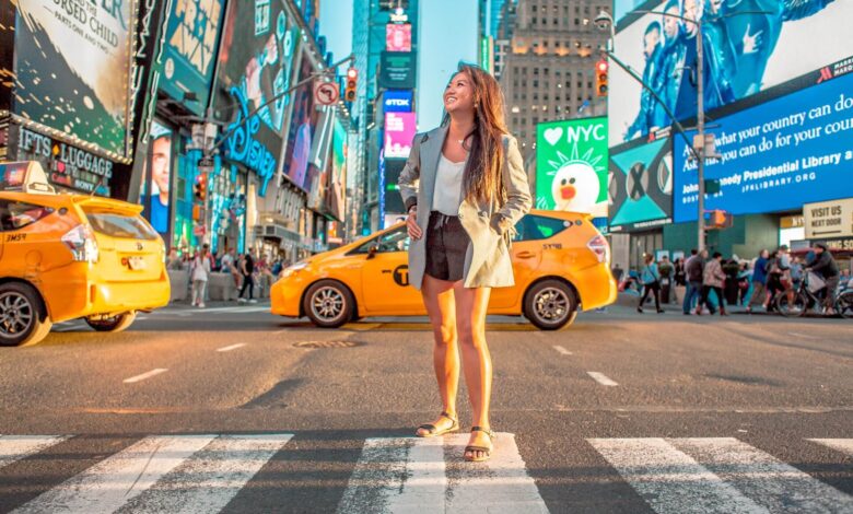 Enjoy Life In New York City - Woman standing on a crosswalk in NYC