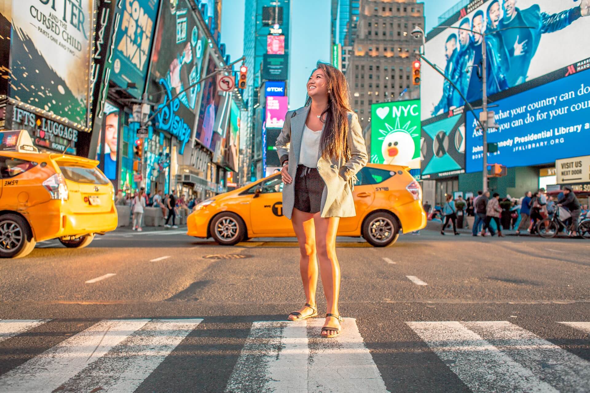 Enjoy Life In New York City - Woman standing on a crosswalk in NYC