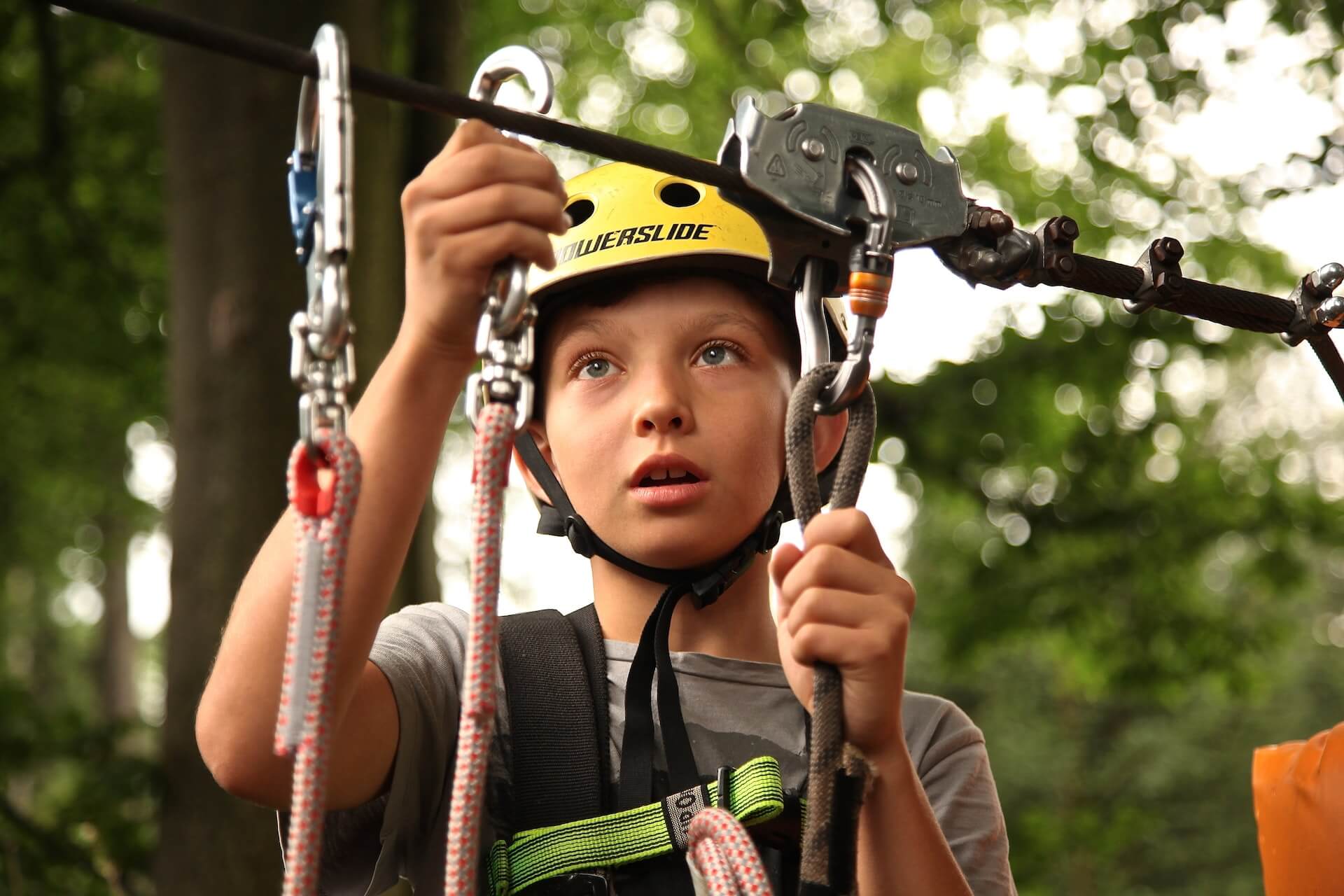 A boy with a hamlet prepared for climbing