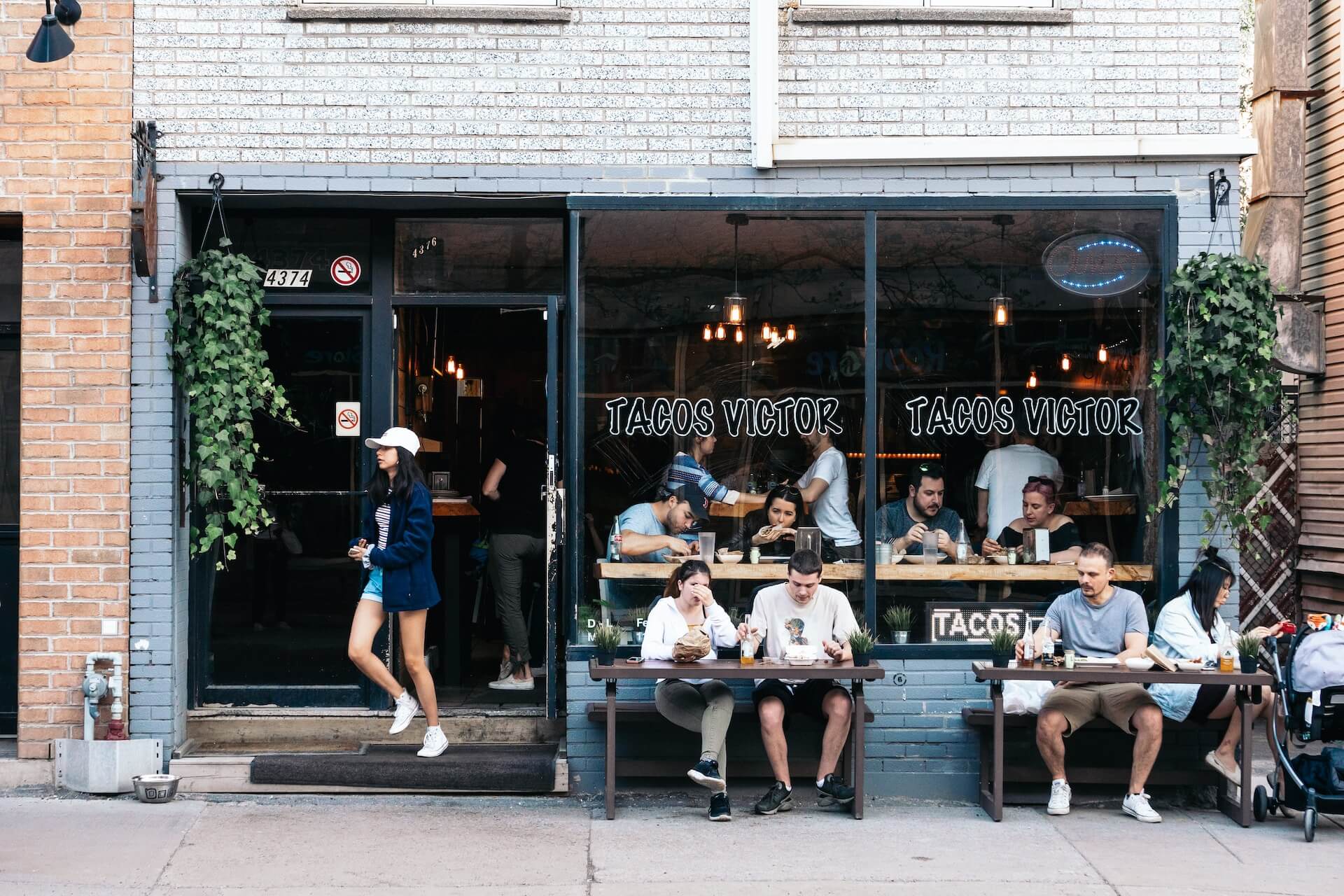 People sitting outside a taco restaurant