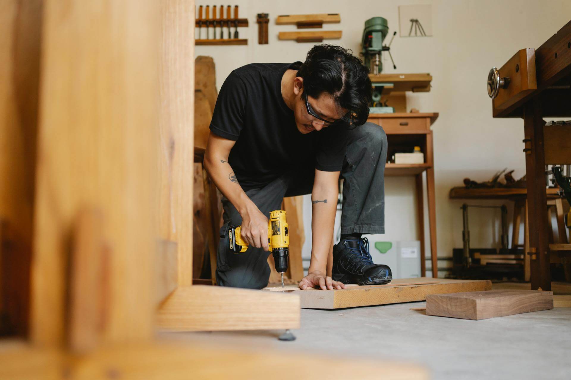 Man working with wood and tools in his home