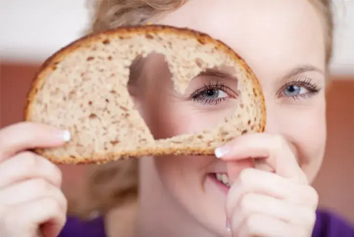 women piece bread heart